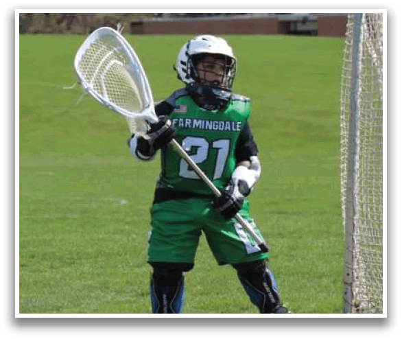 A young boy wearing a green jersey and holding a lacrosse stick. AI generated content