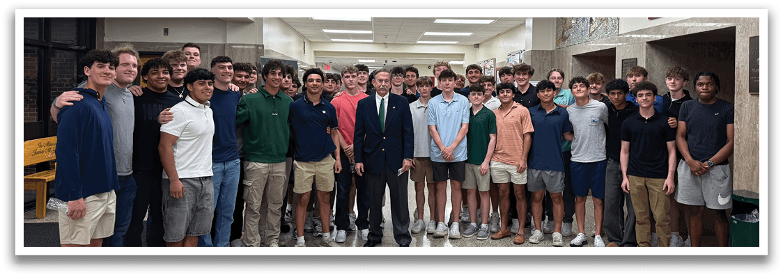 A group of young men wearing blue shirts and white shorts. Description generated by AI