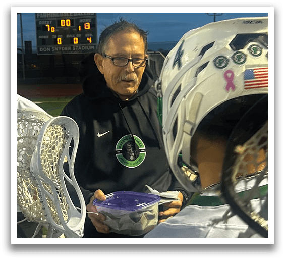 A man holding a purple container. Description generated by AI