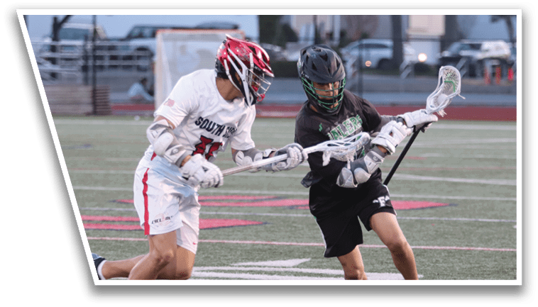 Two men playing lacrosse on a field. Description generated by AI