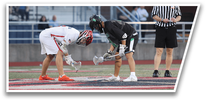 Two men are bending over a white line on a field. Description generated by AI