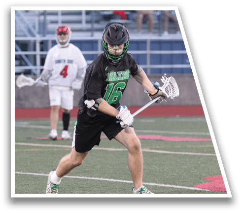 A man in a black and green shirt is holding a lacrosse stick. Description generated by AI