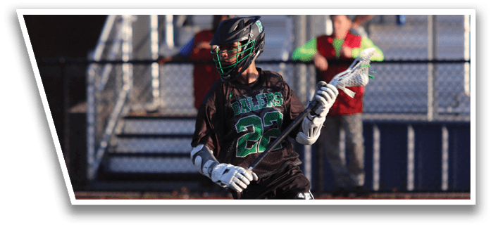 A man in a green and black uniform is playing baseball. Description generated by AI