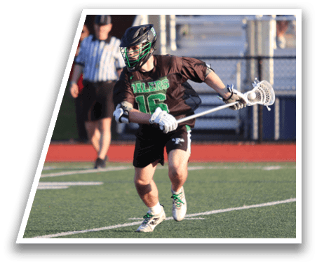 A man in a green jersey is running with a lacrosse stick. Description generated by AI