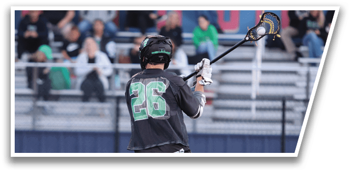 A man in a black and green shirt is holding a yellow and black lacrosse stick. Description generated by AI