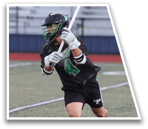 A man in a black shirt and green shorts is holding a baseball bat. Description generated by AI