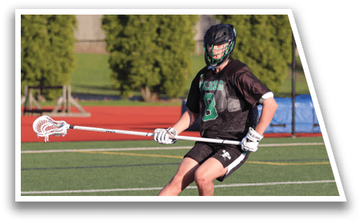 A man is holding a lacrosse stick and running on a field. Description generated by AI