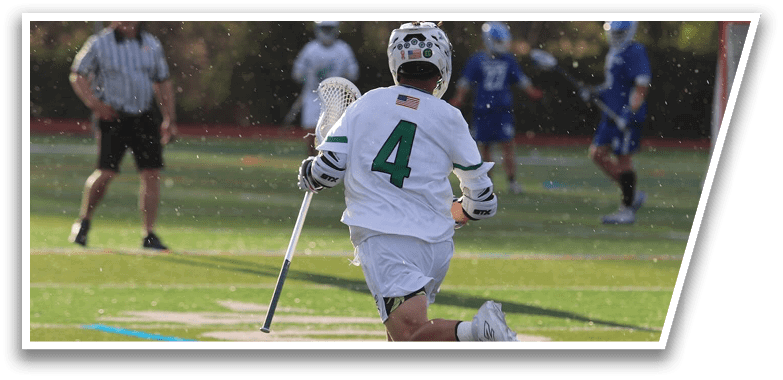 A man running with a stick in his hand. Description generated by AI