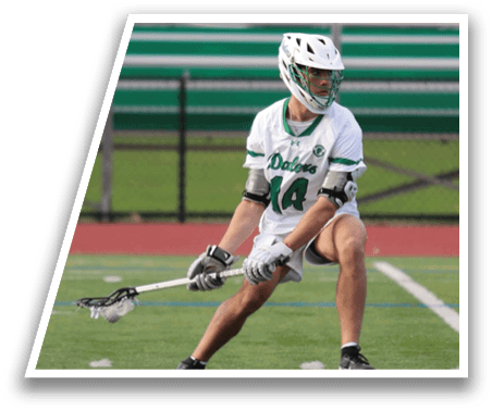 A man wearing a white and green uniform is holding a lacrosse stick. Description generated by AI