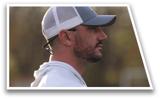 A man wearing a white shirt and a blue hat. Description generated by AI