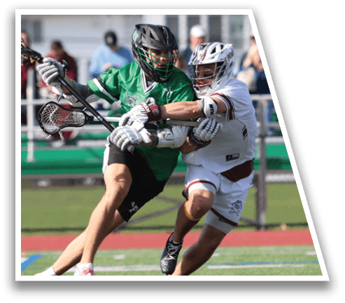 A man in a green shirt and black shorts is holding a lacrosse stick. Description generated by AI