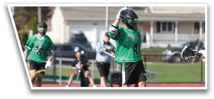 A group of men playing a game of lacrosse. Description generated by AI