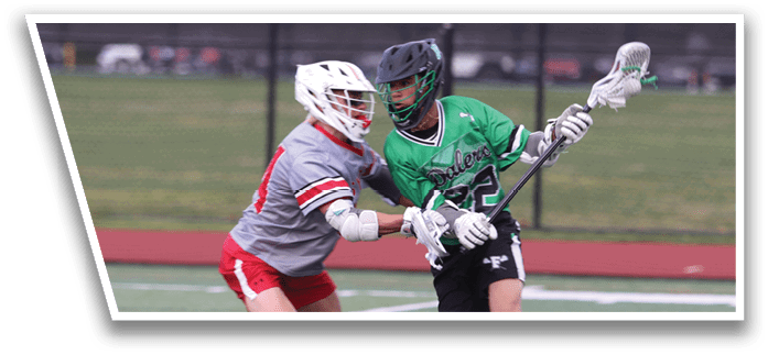 Two men playing lacrosse on a field. Description generated by AI