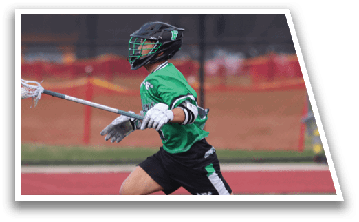 A man in a green shirt and black shorts is running with a white and black lacrosse stick. Description generated by AI