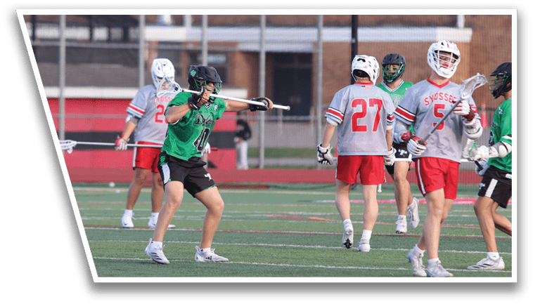 A group of people playing a game of lacrosse. Description generated by AI