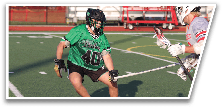 A man in a green jersey is running on a field. Description generated by AI