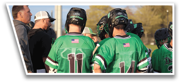 A group of young men wearing green jerseys and white hats. Description generated by AI
