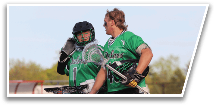 Two people wearing green shirts and black shorts. Description generated by AI