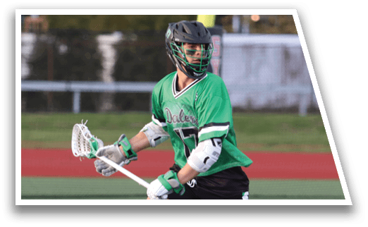 A man in a green shirt and black shorts is running with a lacrosse stick. Description generated by AI
