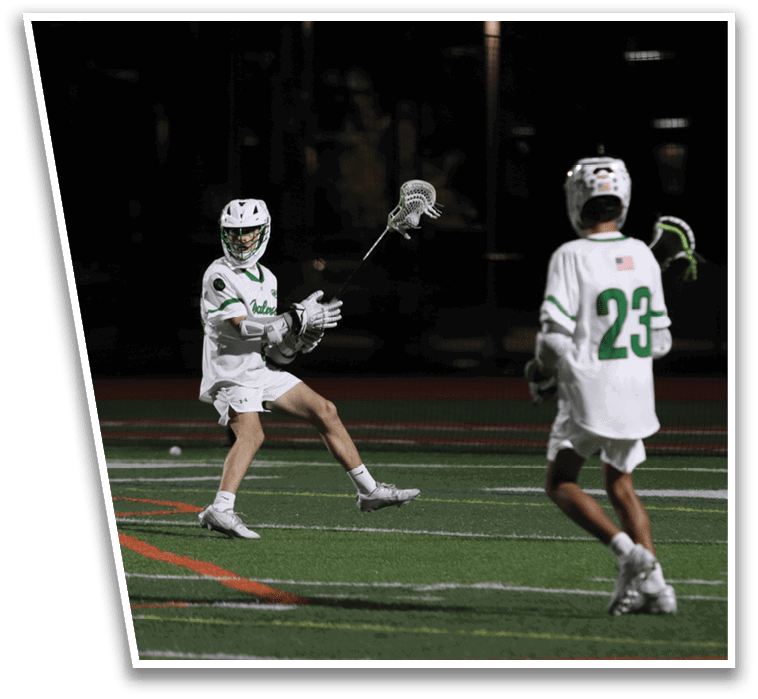 Two men playing lacrosse on a field. Description generated by AI