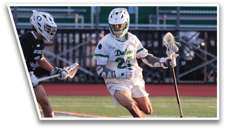 A man in a green and white uniform is running on a field. Description generated by AI