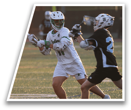 A man in a white shirt and black shorts is playing lacrosse. Description generated by AI