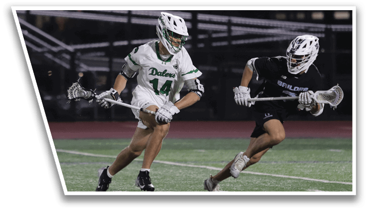 Two men playing lacrosse on a field. Description generated by AI
