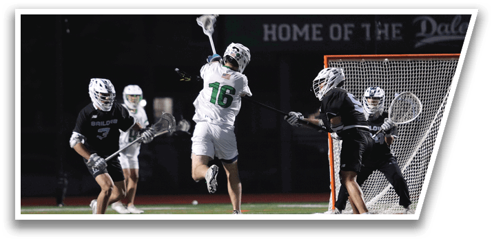 A group of people playing lacrosse on a field. Description generated by AI