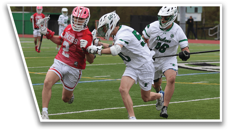 A group of men playing lacrosse on a field. Description generated by AI