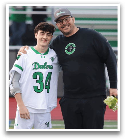 A man and a boy standing together. Description generated by AI