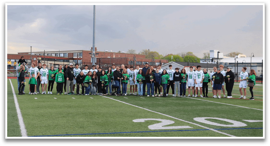 A group of people standing on a football field. Description generated by AI