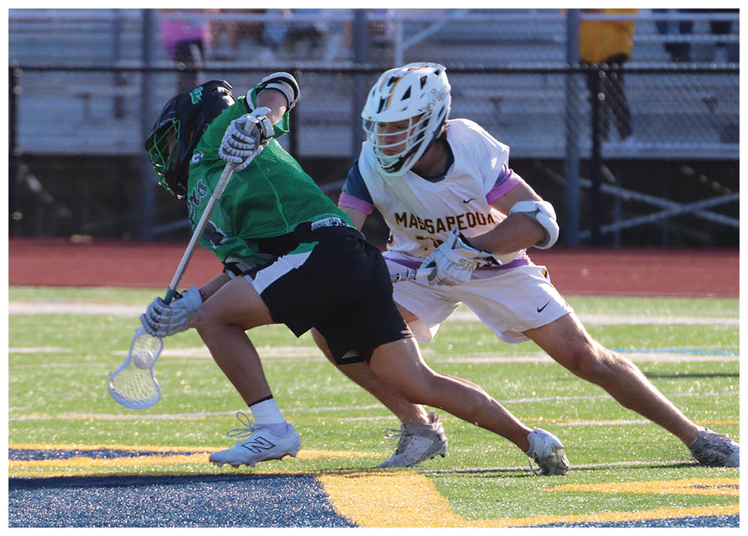 A man in a green shirt and black shorts is running with a lacrosse stick. Description generated by AI