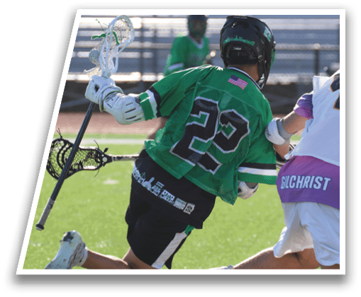 A man wearing a green shirt and white shorts is playing lacrosse. Description generated by AI