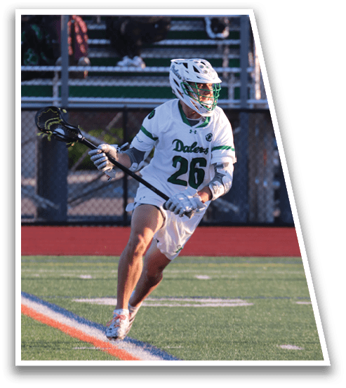 A man in a white and green uniform is playing lacrosse. Description generated by AI