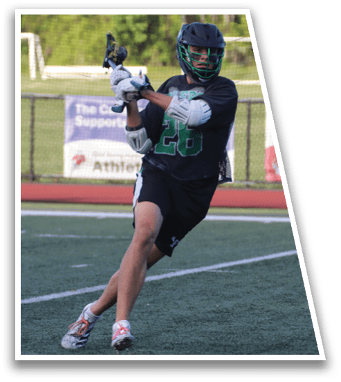 A baseball player in a black shirt and green shorts is swinging a bat. Description generated by AI