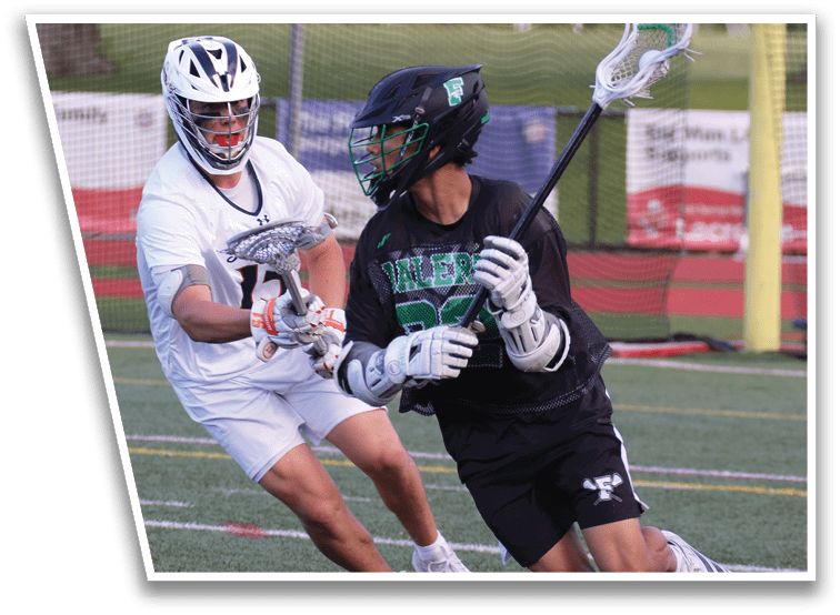 Two men playing lacrosse on a field. Description generated by AI