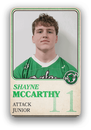 A person wearing a green sports jersey with the name Shayne McCarthy, labeled as an attack junior player with the number 11 on a trading card-style design. Description generated by AI