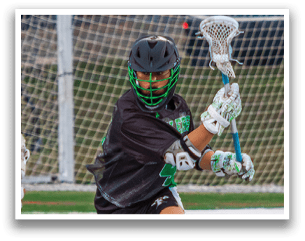 Two men playing lacrosse on a field. One man is wearing a green helmet and the other is wearing a white helmet. AI generated content