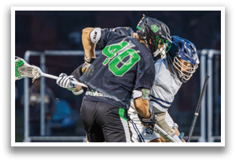 Two men playing lacrosse on a field. One man is holding a stick and the other is holding a stick and a ball. AI generated content