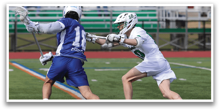 Two men playing a game of lacrosse. Description generated by AI