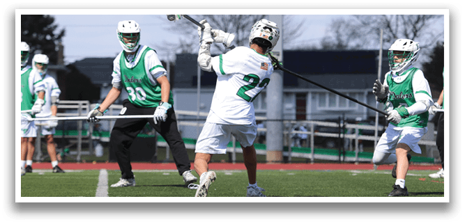 A man in a white jersey is swinging a baseball bat. Description generated by AI