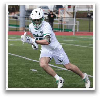 A man wearing a white shirt and green shorts is running on a field. Description generated by AI