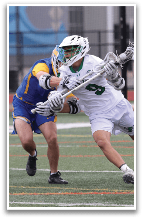 A man in a white shirt and green shorts is running with a lacrosse stick. Description generated by AI