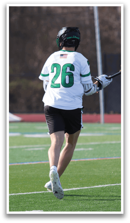 A man is playing a game of lacrosse. Description generated by AI