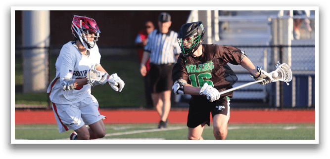 A man in a green jersey is running with a lacrosse stick. Description generated by AI