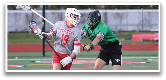 A man in a grey shirt and red shorts is running with a lacrosse stick. Description generated by AI
