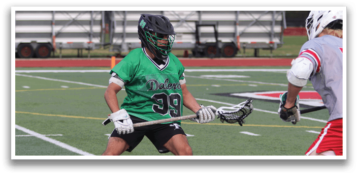 A man wearing a green jersey is playing lacrosse. Description generated by AI
