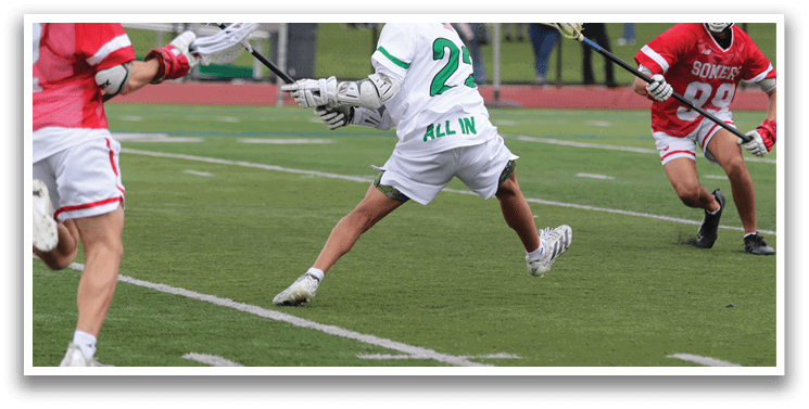 A group of people playing a game of lacrosse. Description generated by AI