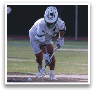 A man in a green jersey is swinging a lacrosse stick, attempting to hit a sports ball. AI generated content
