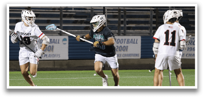A man wearing a white and green jersey is running on a field. Description generated by AI